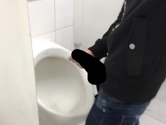 Gay boy is jerking off in public restroom and shoot his load in a urinoir